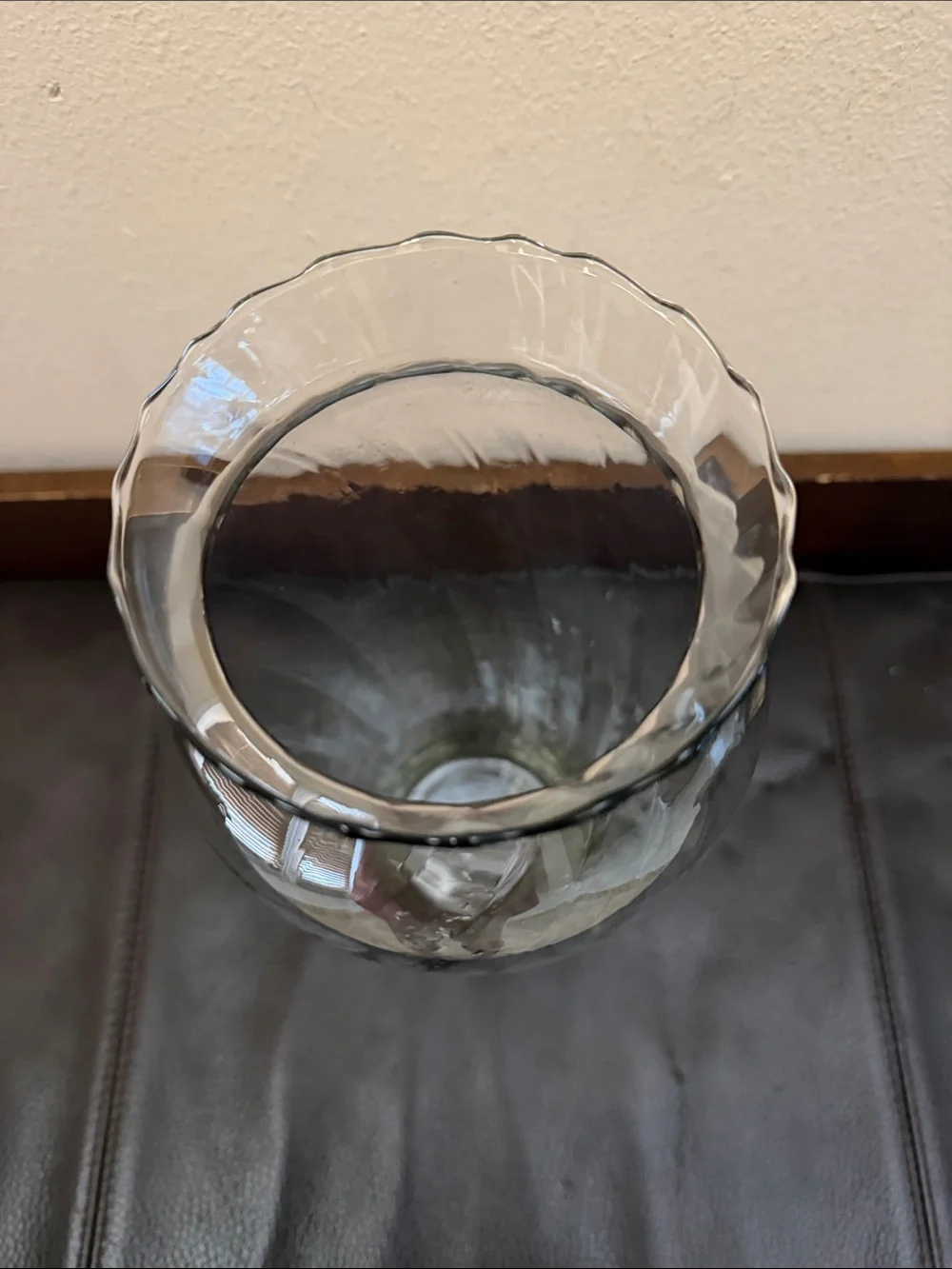 Clear Glass Vase Features Scalloped Rim Opening Tapering Down to a Narrow Base